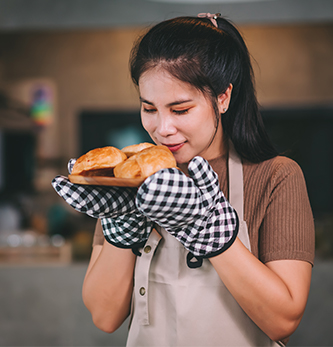 Image of woman smelling a new baked bread