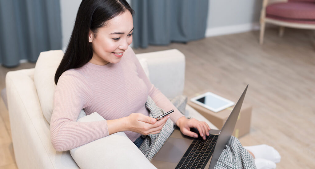 Asian person using a laptop